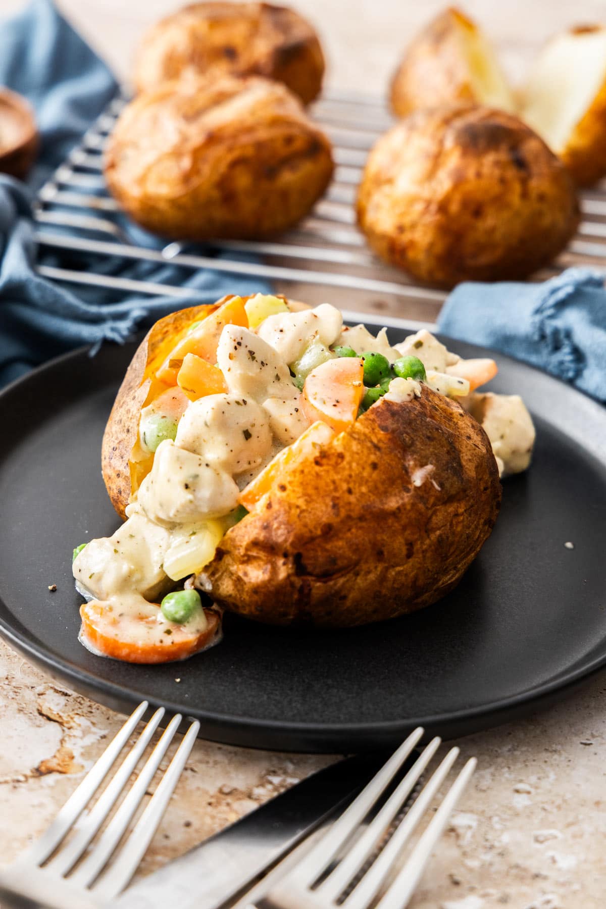 Golden brown Chicken Pot Pie Baked Potato topped with melted cheese and fresh parsley