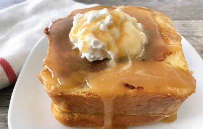 Stack of Copycat Kneaders Chunky Cinnamon French Toast topped with whipped cream and caramel syrup