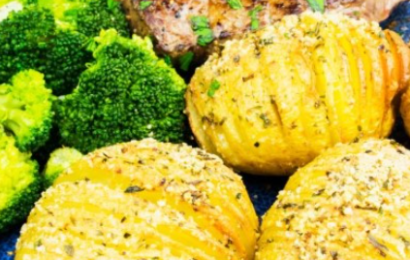 A basket filled with golden-brown cheese and vegetable savoury picnic muffins on a checkered cloth.