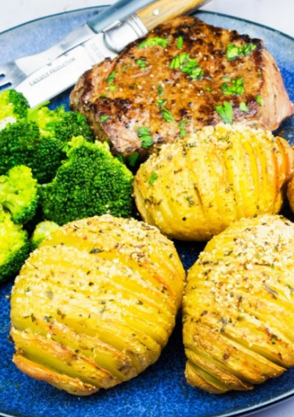 A basket filled with golden-brown cheese and vegetable savoury picnic muffins on a checkered cloth.