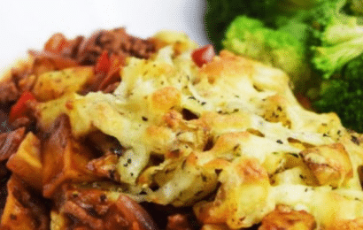 A bubbling Crispy Roast Potato and Bolognese Bake with melted mozzarella cheese and golden potatoes