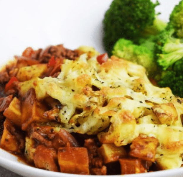 A bubbling Crispy Roast Potato and Bolognese Bake with melted mozzarella cheese and golden potatoes