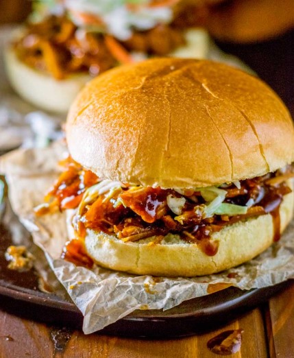 Close-up of juicy Sweet Crock Pot Pulled Pork shredded and smothered in BBQ sauce