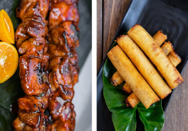 A festive spread of charred Filipino pork BBQ skewers and golden-brown crispy lumpia spring rolls served with a side of sweet chili dipping sauce.
