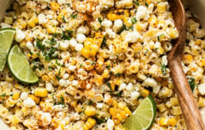 A large bowl of Mexican Street Corn Pasta Salad with grilled corn, cotija cheese, fresh cilantro, and creamy lime dressing.