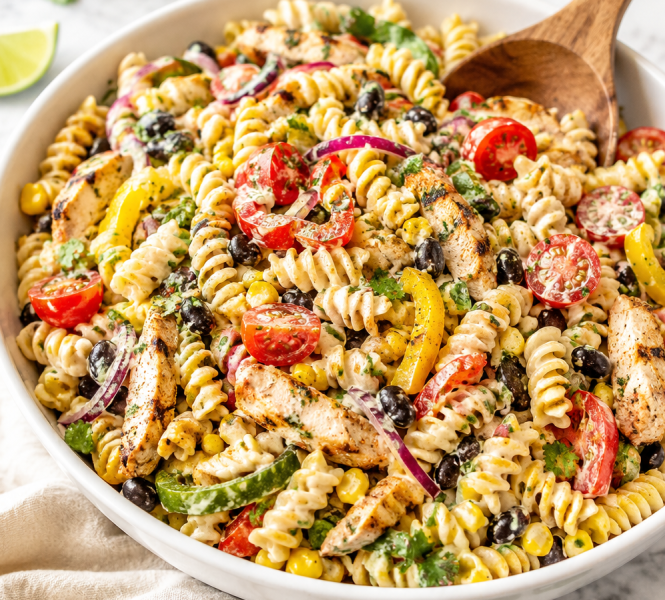 A large bowl of colorful Southwest Fajita Pasta Salad packed with black beans, corn, bell peppers, and grilled chicken, tossed in a creamy lime dressing.