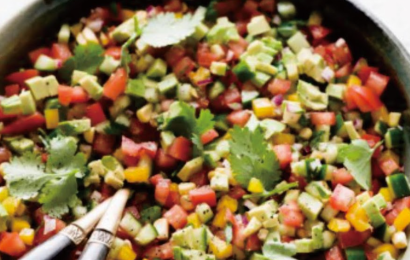 A vibrant bowl of fresh salsa salad with chopped tomatoes, black beans, sweet corn, red onion, and cilantro tossed in a lime dressing.