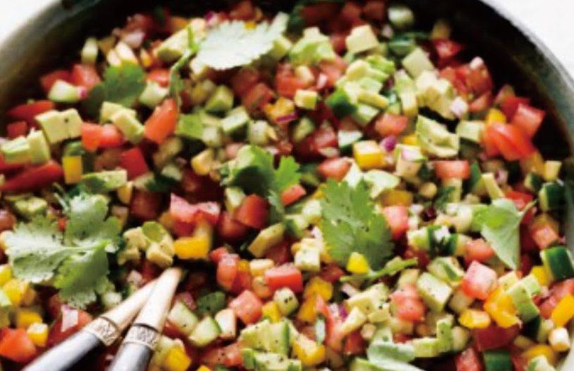 A vibrant bowl of fresh salsa salad with chopped tomatoes, black beans, sweet corn, red onion, and cilantro tossed in a lime dressing.